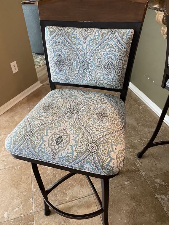 Swivel barstool reupholstered in a blue paisley fabric
